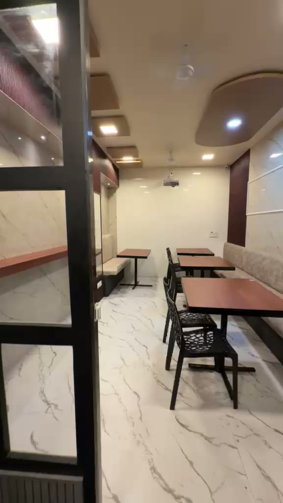 Dining area with wooden tables and marble walls